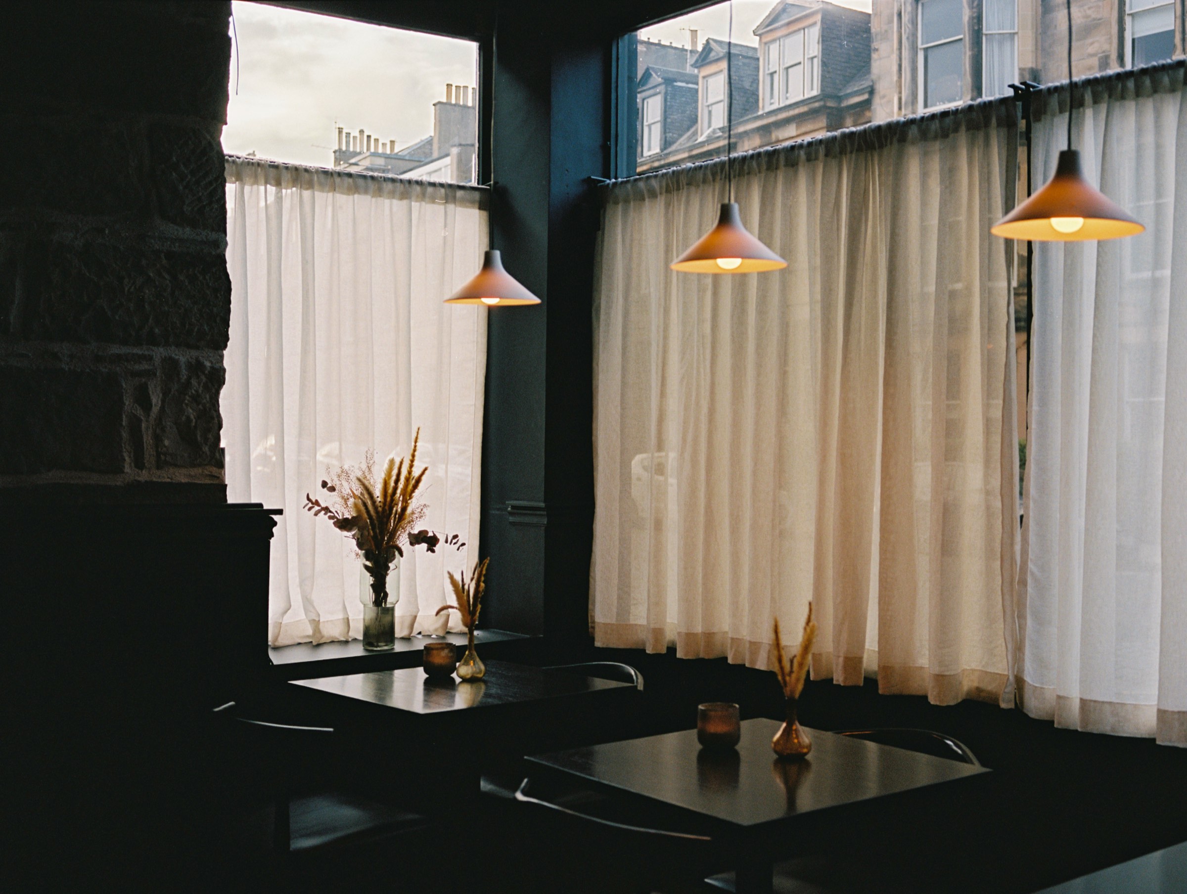 Window tables and lamps in the Cardinal dining room, shot on film