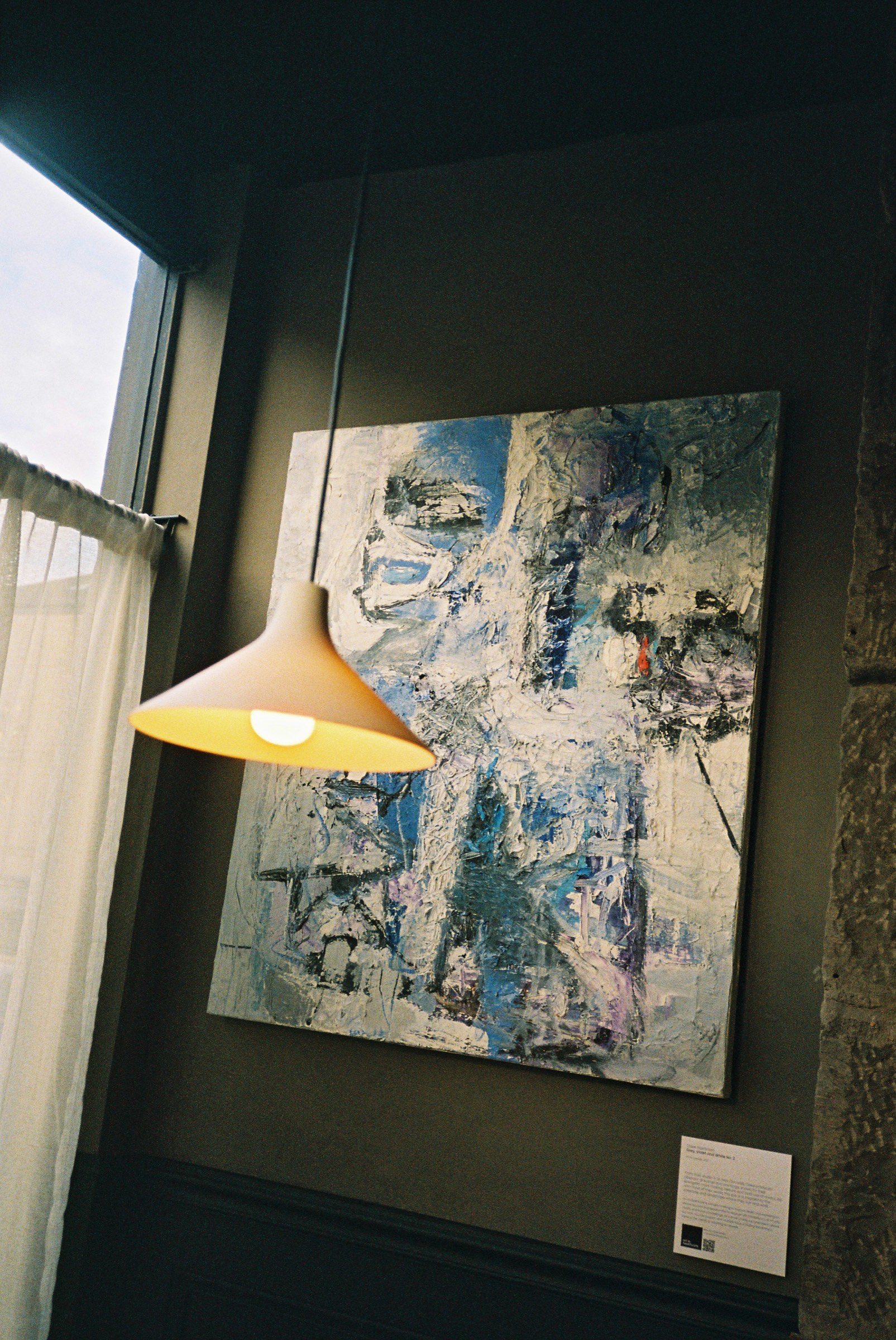 A pendant lamp beside the painting in the Cardinal dining room