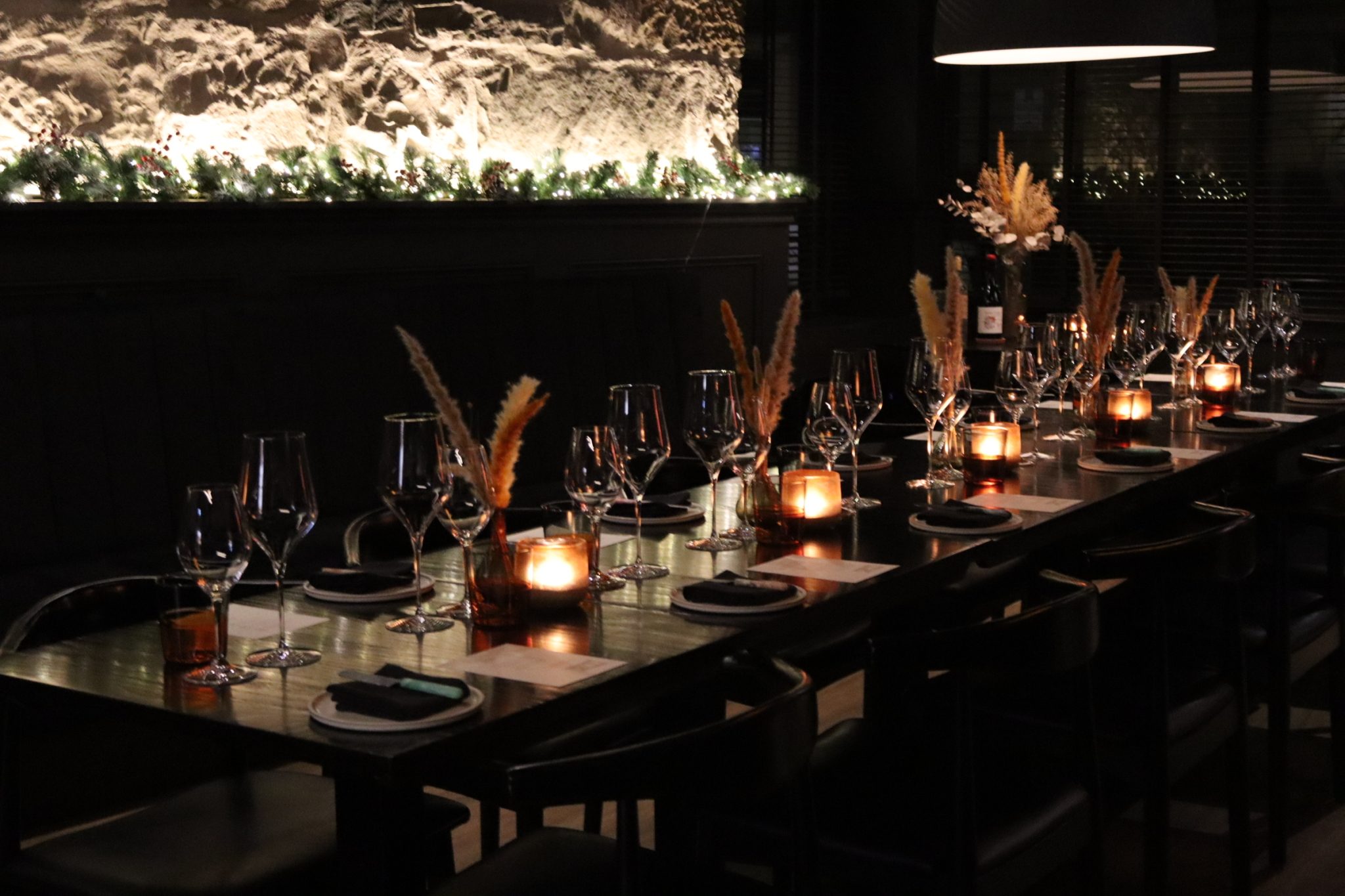 The private dining table set at Cardinal, Edinburgh — candlelight, glassware and seasonal florals